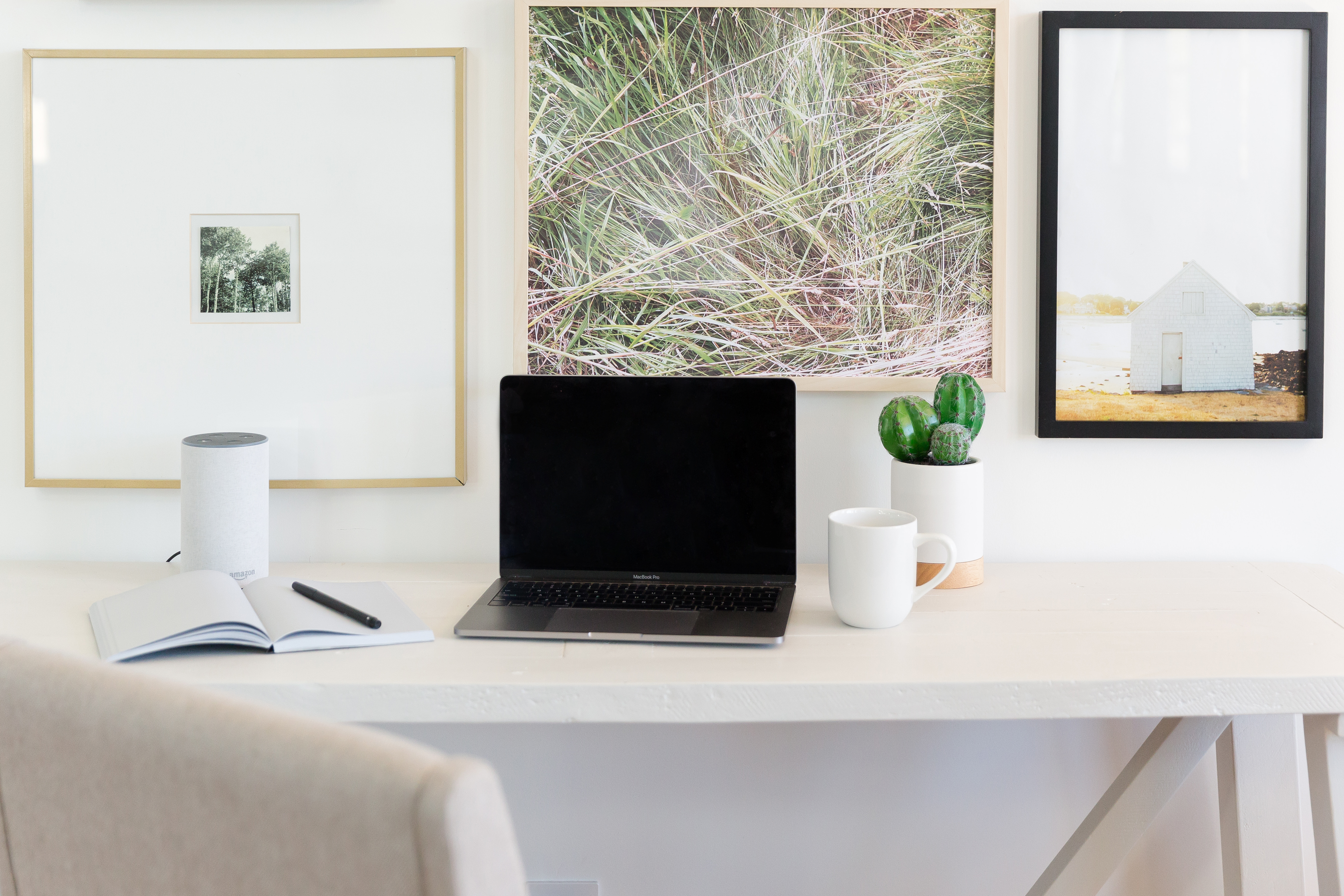 macbook on white desk with neutral colors